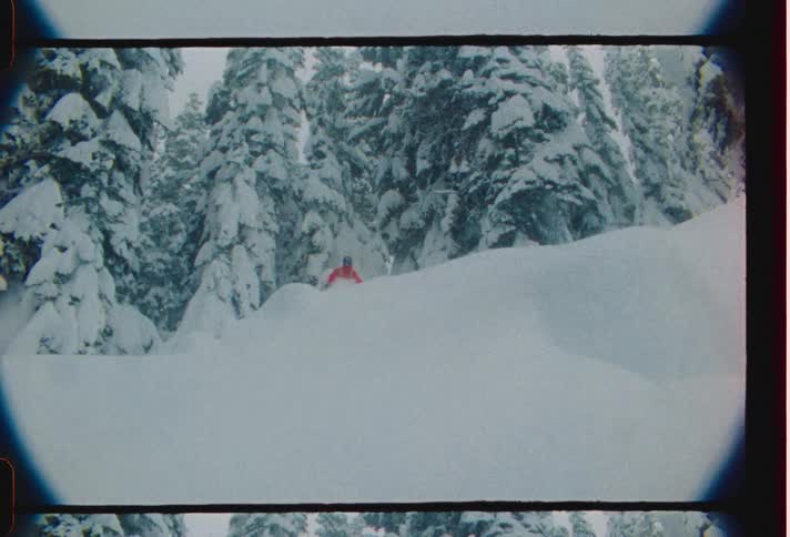 A person skiing at high speed down a mountain during a blizzard