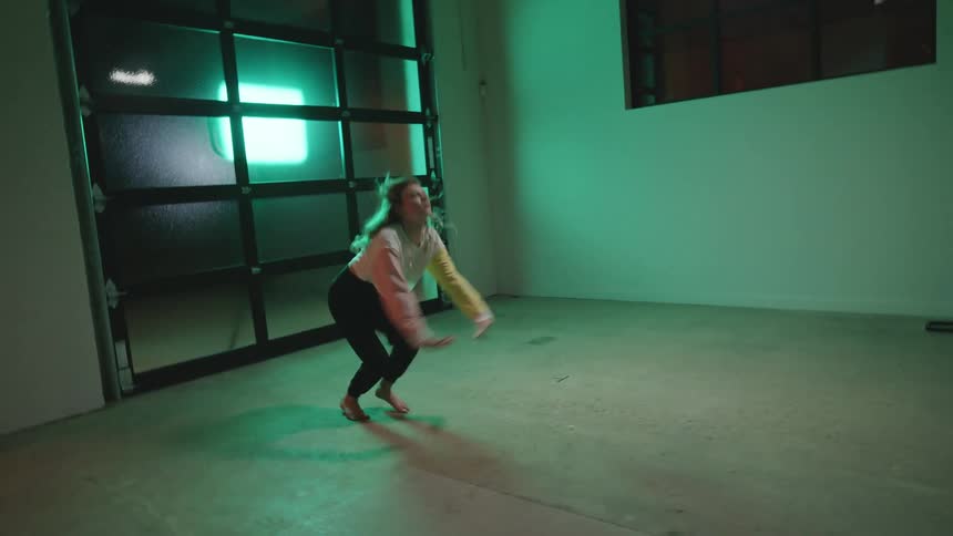 A woman dancing in an empty room