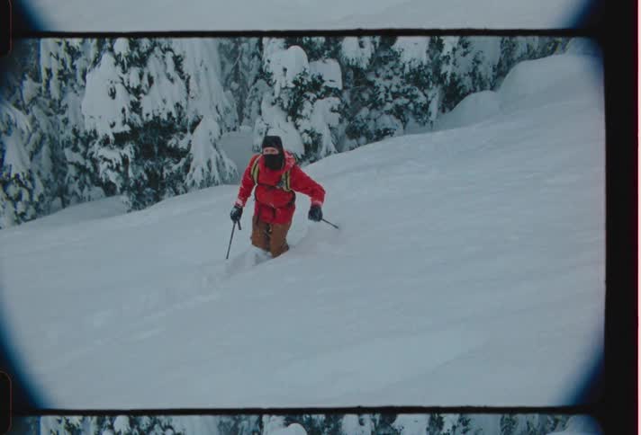 A person climbs a snowy mountain during a blizzard