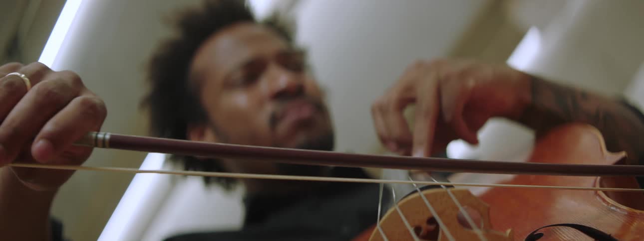 Closeup of a man playing the cello