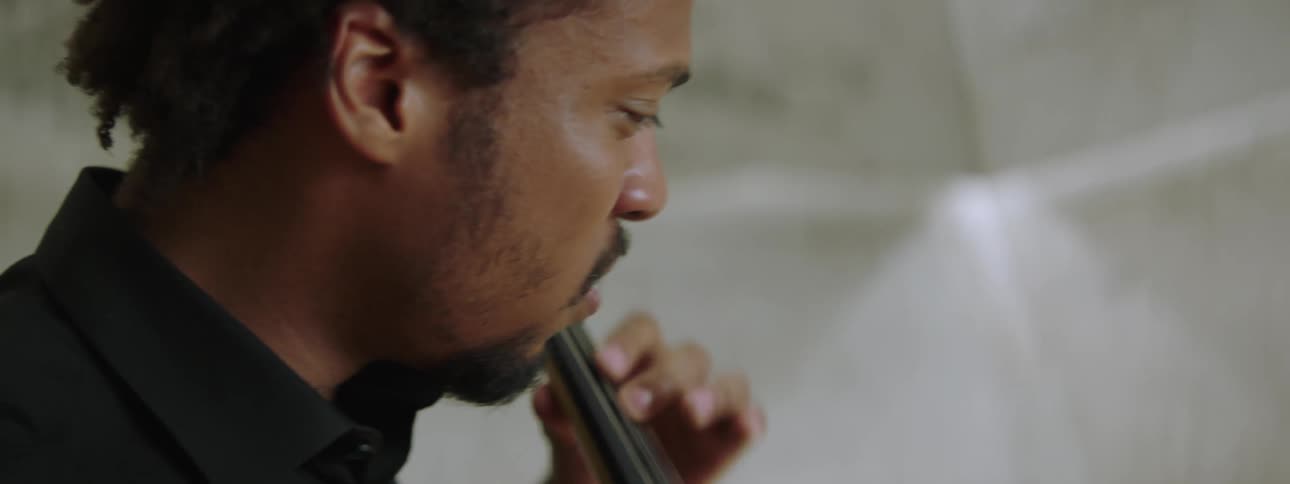 Closeup of the emotional face of a man playing the cello