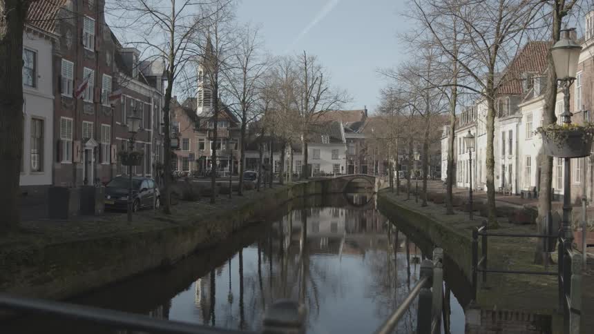 A canal in the middle of a residential neighborhood during the cold morning