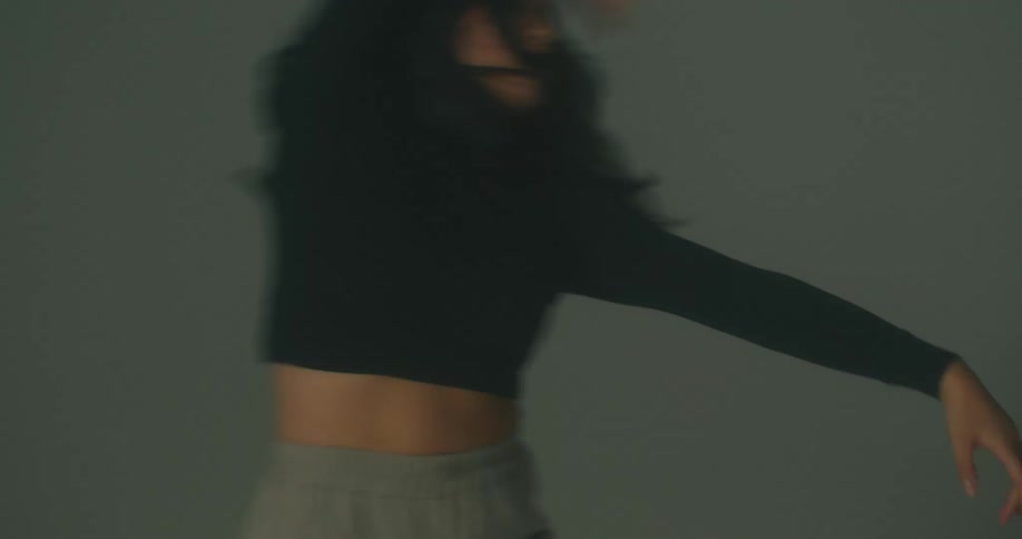 A woman doing contemporary dance moves in a room