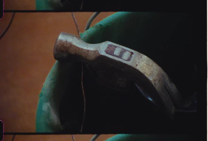 Head of hammer in green bin rests on top of cord