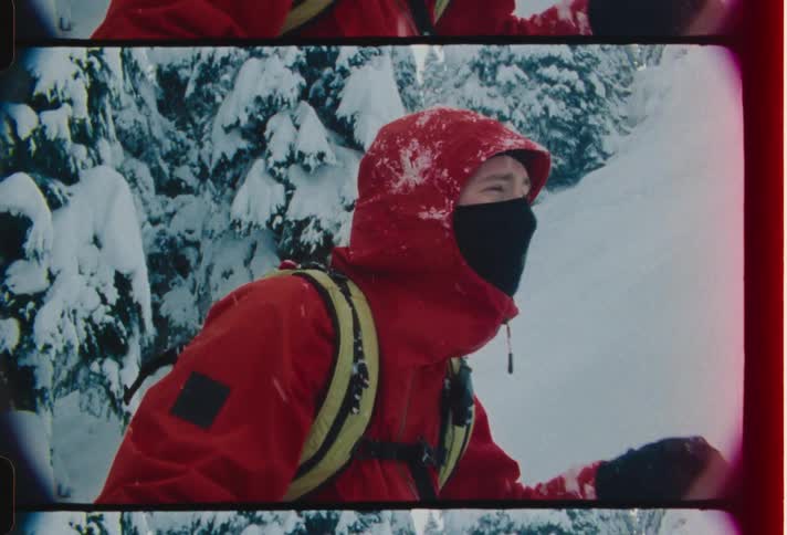 Man climbing a mountain covered in snow