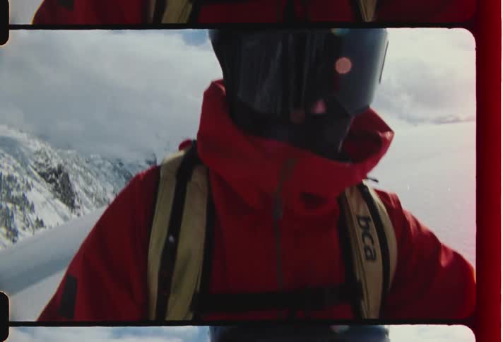 Person with helmet on snowcovered mountain peak during daytime