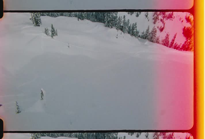 A person jumps skiing in the snow from a snowy mountain