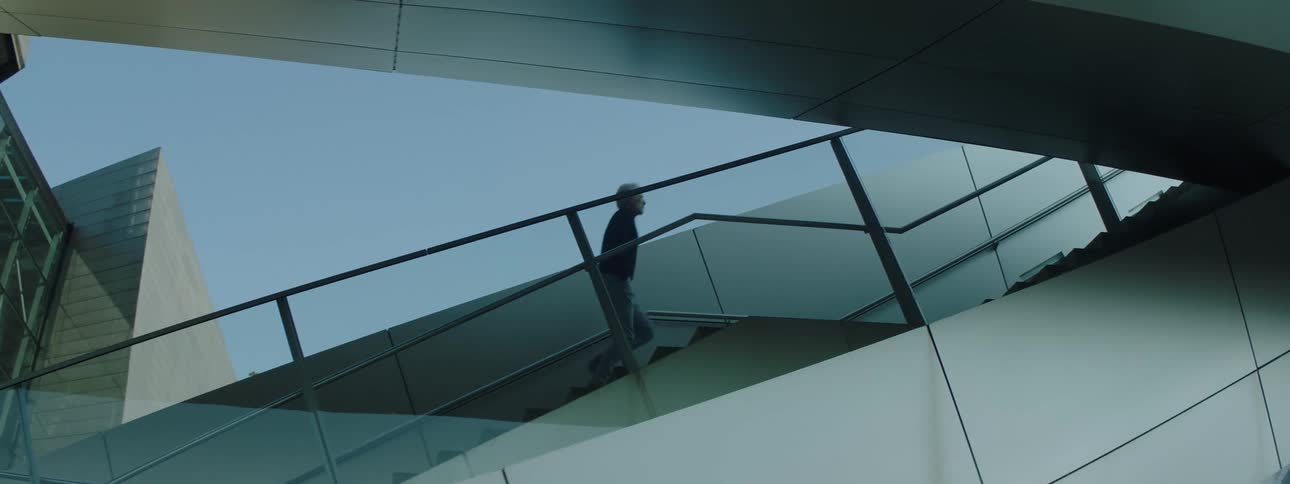 A man runs up the stairs of a building