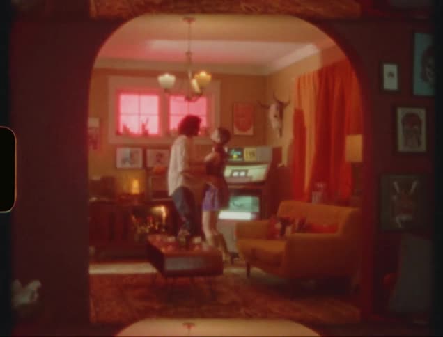 Male and female dancing together in the living room