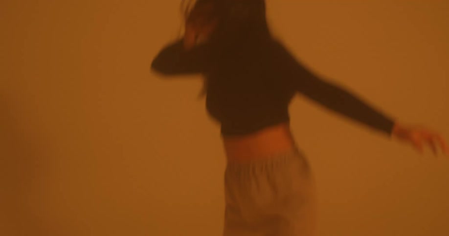 Lady dancing in a yellow room