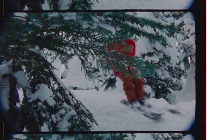 Person descending a snowcovered mountain on a snowboard