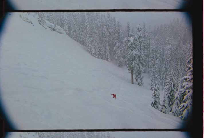 A person works hard to hike up a very snowy mountain slope
