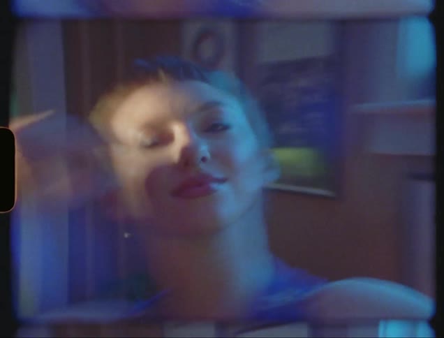 A lady dancing in a room filled with wall portraits