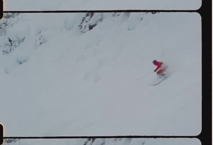 Experienced skier skis down a backcountry slope in loose snow