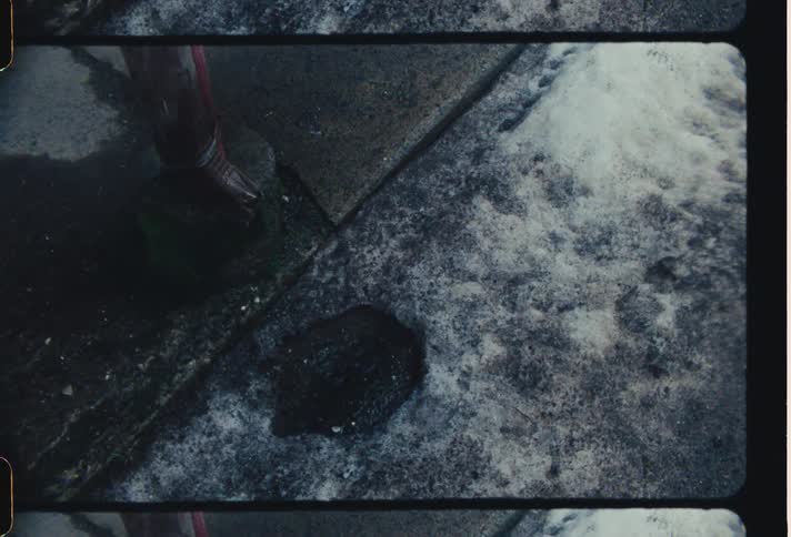 Drops falling into a puddle on the asphalt