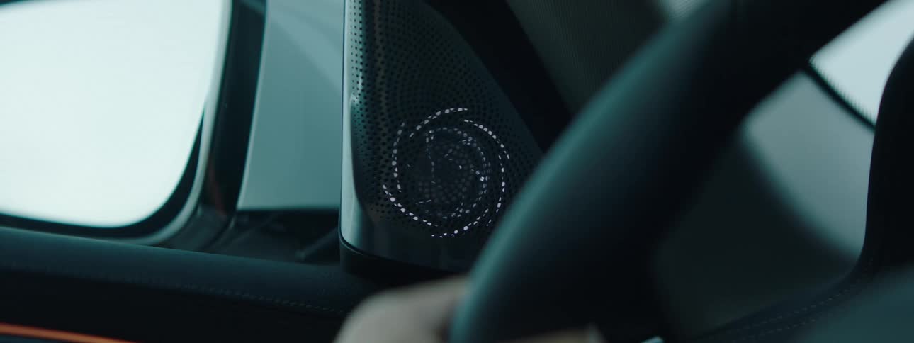 Interior design of a vehicle with a white light on the sound outlet