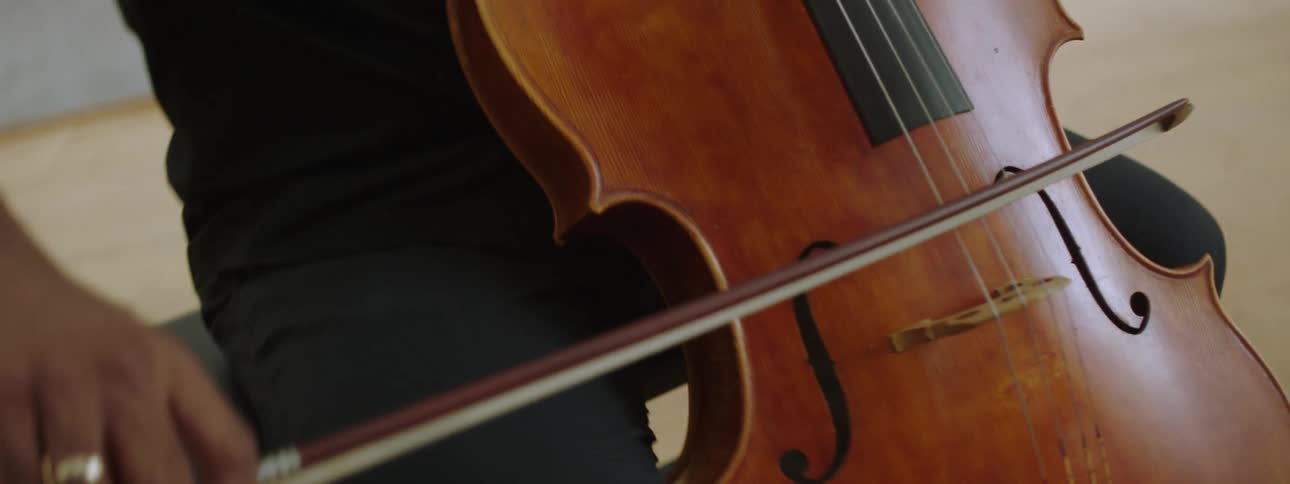 Man playing a violin gently