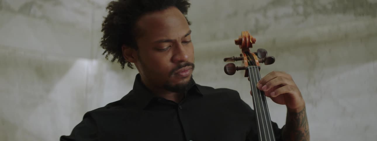 An artist playing the cello at a concert