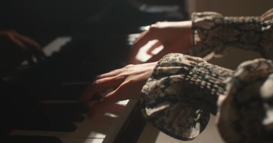 A pair of female hands playing piano