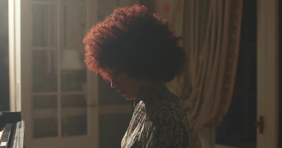 A woman playing the piano during the day