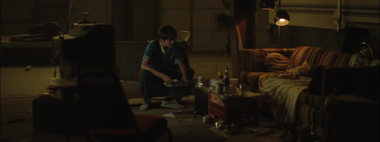 Teenager reading magazines in the living room