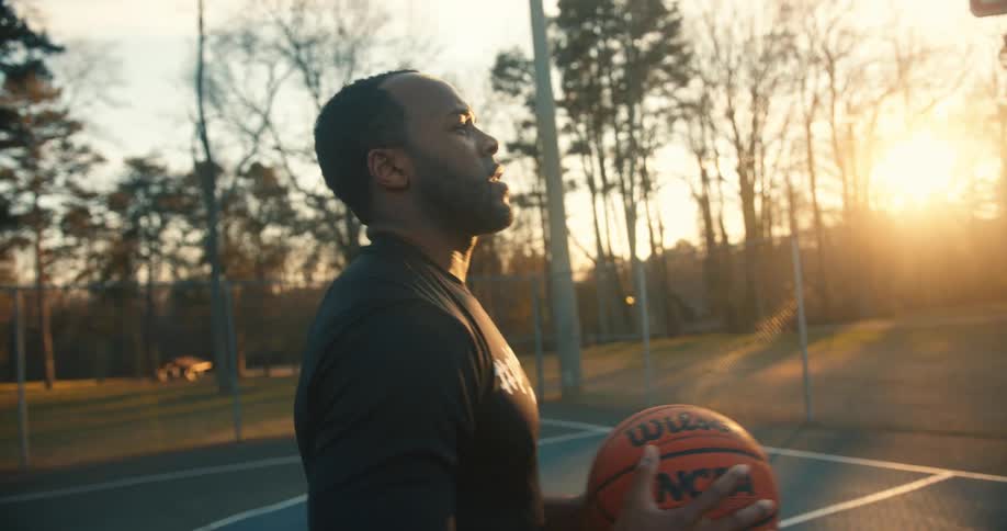 Man on a court with a basketball shooting towards the sixth