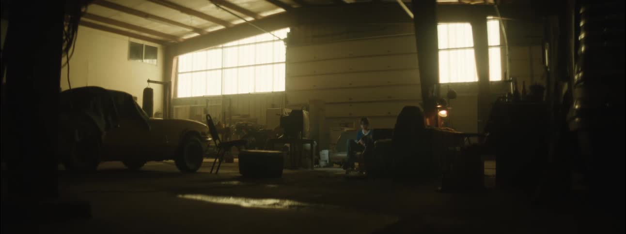 Two people enter a garage transformed into a loft