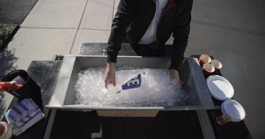 Person placing ice on a metal platform