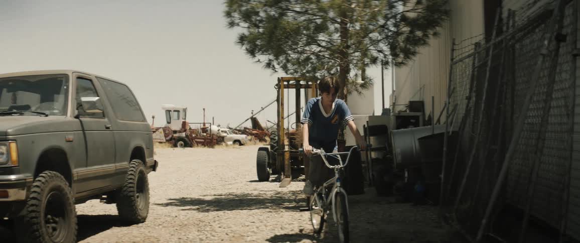 A clip of a boy riding and parking his bicycle