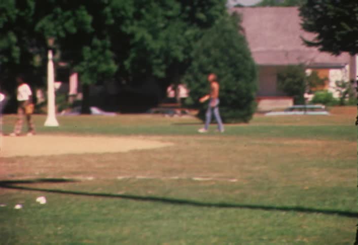 Men play baseball on a baseball field