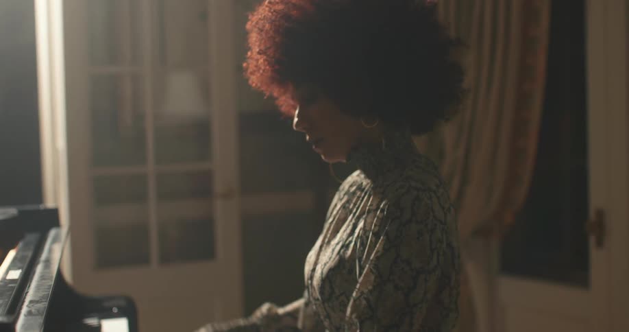 A woman playing the piano in a music room