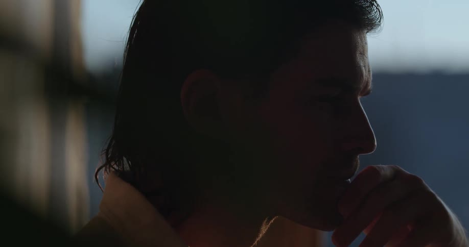Side portrait of a thoughtful man placing one of his hands on his face