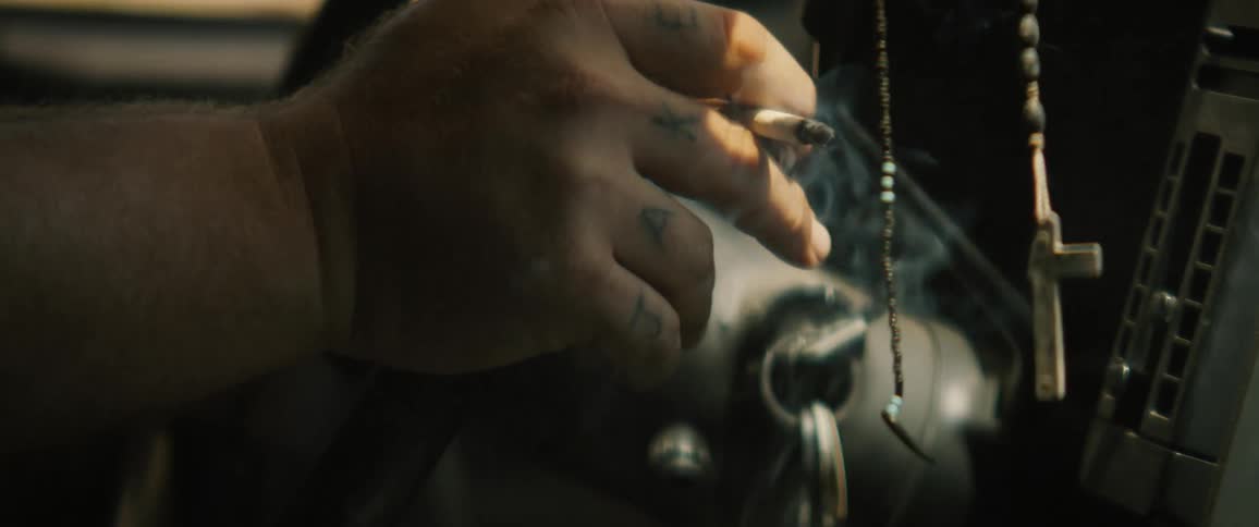 A person smoking a cigarette while driving