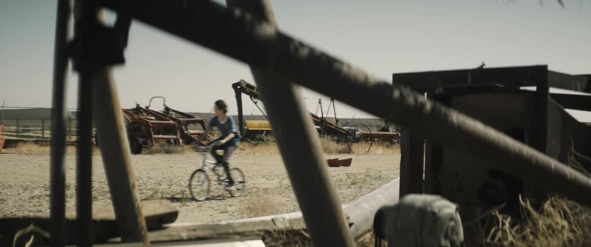 Boy riding a bike during the day