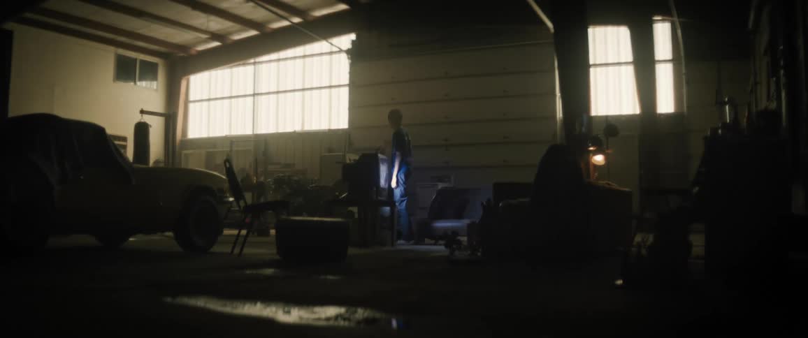 A person watching tv on a garage transformed into a loft