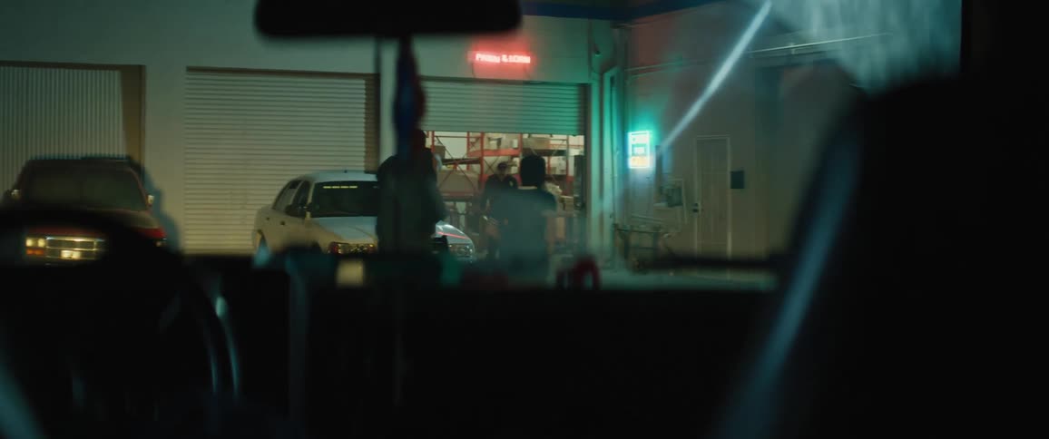 Two masked men exit a vehicle to rob a store at gunpoint