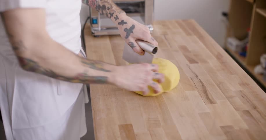 A clip of a chef slicing a dough