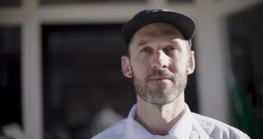 Chef wearing a black cap a white shirt and apron