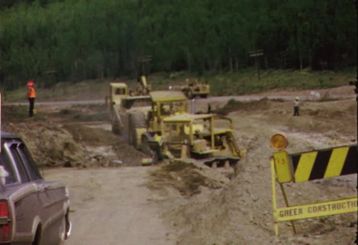 Construction machinery working at the edge of a forest
