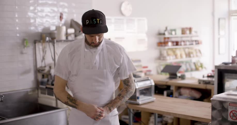 A man in an apron in the kitchen