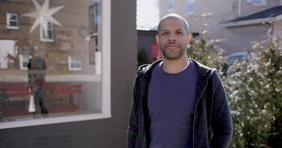 A clip of a man in front of a house