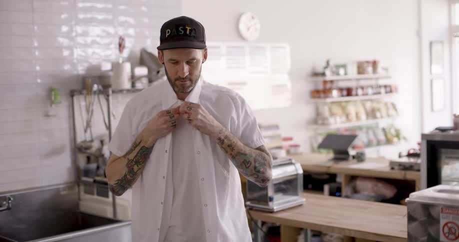 An employee puts on his uniform for work
