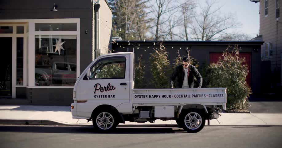 Man getting out of his small truck and setting up his food truck