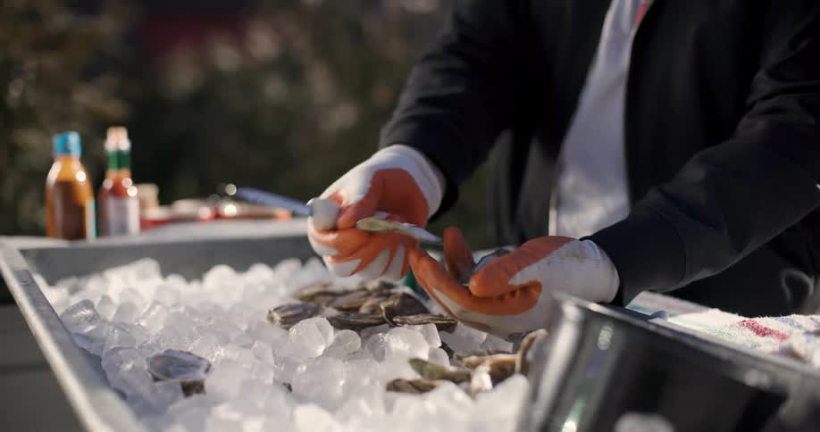 A clip of a person preparing an oyster