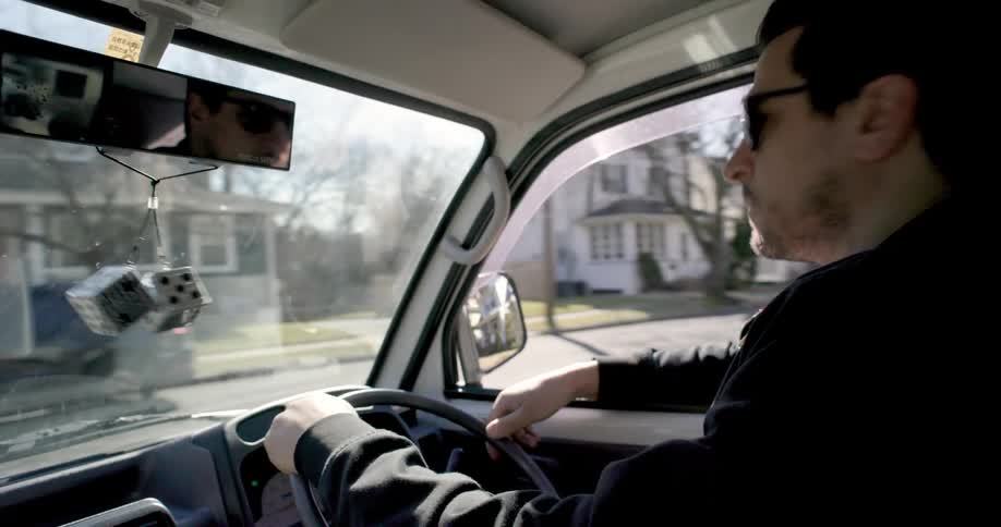 Side portrait of a man driving food truck