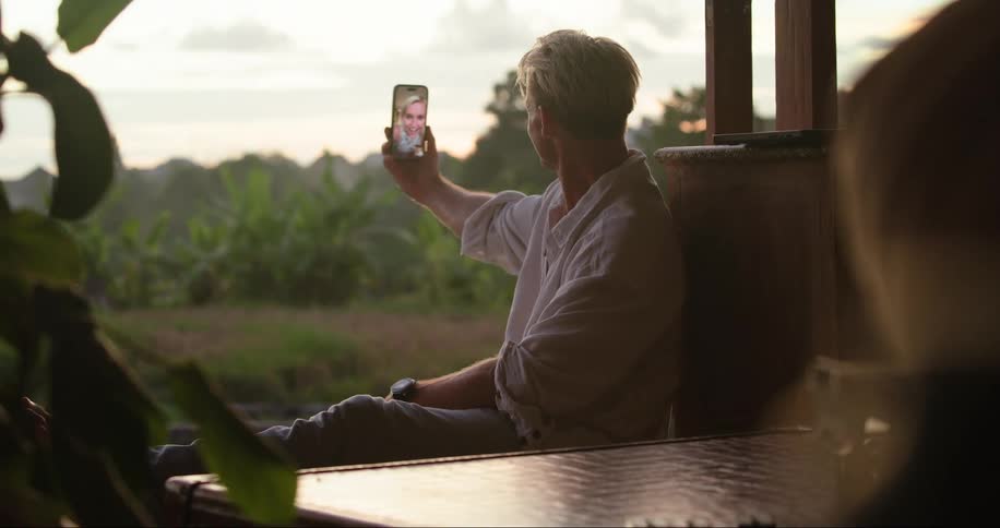 A man on a video call admires the forest