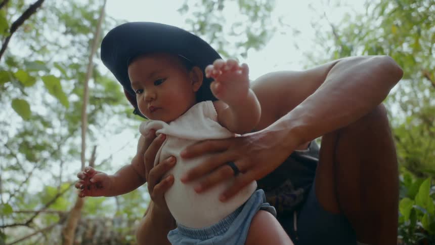 A father is holding his son