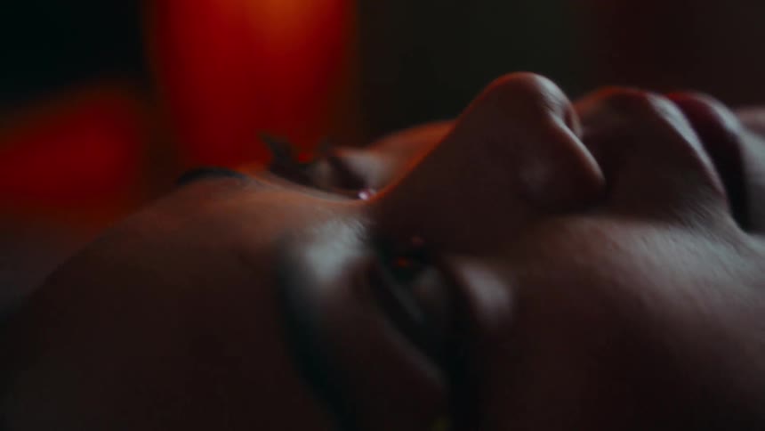 Close up of a young Asian woman lying on the floor in deep contemplation