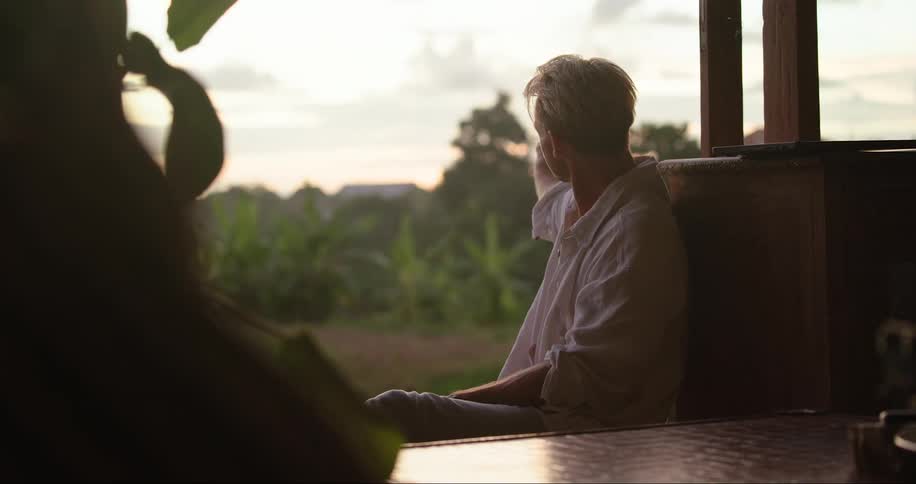 A man is on a video call on his porch