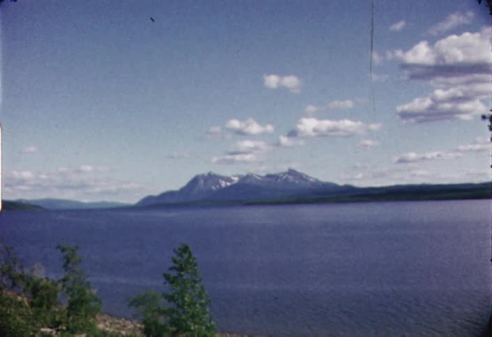 The large lake leads to a mountain in the distance